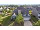Aerial view of gray sided home featuring a manicured lawn, mature landscaping and a two-car garage at 3267 Lock Erne Ave, Kannapolis, NC 28081