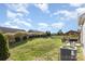 Landscaped backyard with a built-in grill and a covered patio area at 3267 Lock Erne Ave, Kannapolis, NC 28081