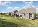 View of the home's backyard with a patio, grill, and a covered outdoor seating area for relaxation and entertainment at 3267 Lock Erne Ave, Kannapolis, NC 28081