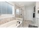 Bathroom showcasing a soaking tub, separate shower with glass door, and tiled walls at 3267 Lock Erne Ave, Kannapolis, NC 28081
