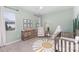 Charming Bedroom with sage green walls, featuring a crib, a rocking chair, and whimsical decor at 3267 Lock Erne Ave, Kannapolis, NC 28081