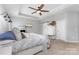 Charming bedroom featuring a sliding barn door, neutral paint, and a decorative ceiling fan at 3267 Lock Erne Ave, Kannapolis, NC 28081