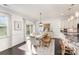 Bright dining area featuring a wooden table, a decorative rug, and access to the outdoor deck at 3267 Lock Erne Ave, Kannapolis, NC 28081