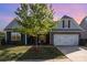Charming home featuring gray siding, stone accents, manicured lawn, and a two-car garage at 3267 Lock Erne Ave, Kannapolis, NC 28081