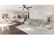 Open-concept living space featuring hardwood floors, a large sectional sofa, and adjacent kitchen and dining areas at 3267 Lock Erne Ave, Kannapolis, NC 28081