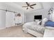Well-lit main bedroom featuring a sliding barn door, ceiling fan, accent wall and bright furniture at 3267 Lock Erne Ave, Kannapolis, NC 28081
