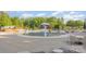 Community pool area featuring a mushroom water feature, lounge chairs, and tables for a relaxing experience at 3267 Lock Erne Ave, Kannapolis, NC 28081