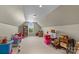 Spacious attic with a window, sloped ceilings, neutral carpet, and plenty of storage opportunities at 34843 Ellis Spring Ct, Albemarle, NC 28001