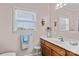 Light and bright bathroom with vanity, mirror, and window for natural light at 34843 Ellis Spring Ct, Albemarle, NC 28001