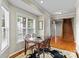 Bright dining room with large window, wooden table and staircase at 34843 Ellis Spring Ct, Albemarle, NC 28001