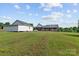 A sprawling backyard with a detached garage and an inviting brick house at 34843 Ellis Spring Ct, Albemarle, NC 28001