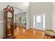 Bright foyer with hardwood floors, a decorative front door, and a view into the dining room at 34843 Ellis Spring Ct, Albemarle, NC 28001
