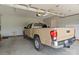 Garage interior showcasing a tan truck parked inside with an automatic garage door opener at 34843 Ellis Spring Ct, Albemarle, NC 28001
