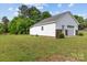 Detached garage with white siding, a garage door, and a side entry door surrounded by lawn at 34843 Ellis Spring Ct, Albemarle, NC 28001