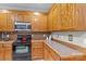 This kitchen features wooden cabinets and countertops with modern stainless steel appliances at 34843 Ellis Spring Ct, Albemarle, NC 28001