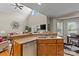 Open-concept kitchen with breakfast bar seamlessly connecting to living area at 34843 Ellis Spring Ct, Albemarle, NC 28001