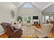 Open-concept living room with a fireplace, hardwood floors, and access to the outdoor patio at 34843 Ellis Spring Ct, Albemarle, NC 28001