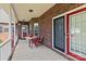 Inviting covered porch featuring outdoor seating, perfect for relaxing or entertaining guests at 34843 Ellis Spring Ct, Albemarle, NC 28001