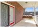 Covered porch showcasing a charming wooden swing, offering a relaxing outdoor space at 34843 Ellis Spring Ct, Albemarle, NC 28001