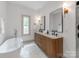 Stylish bathroom features a soaking tub and a double vanity with modern fixtures at 3501 Providence Rd, Charlotte, NC 28211