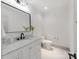 Bathroom featuring new vanity with white marble top, dark faucet and light fixtures at 3501 Providence Rd, Charlotte, NC 28211