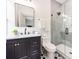 Bathroom featuring a sleek, glass-enclosed shower and a dark vanity at 3501 Providence Rd, Charlotte, NC 28211