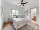 Cozy bedroom featuring a ceiling fan, decorative pillows, side tables with lamps, and an ensuite bathroom at 3501 Providence Rd, Charlotte, NC 28211