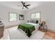 Inviting bedroom with a ceiling fan, two large windows, and a stylish modern decor at 3501 Providence Rd, Charlotte, NC 28211
