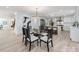 Elegant dining area adjacent to kitchen, showcasing an exquisite chandelier and open floor plan at 3501 Providence Rd, Charlotte, NC 28211