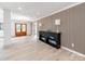 Stylish entryway featuring wood accent wall, modern lighting, and light hardwood floors at 3501 Providence Rd, Charlotte, NC 28211