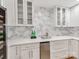 Modern kitchen featuring custom cabinets, mosaic backsplash, quartz counters and stainless beverage center at 3501 Providence Rd, Charlotte, NC 28211