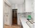 Bright kitchen features custom cabinets, a built-in wine cooler, and a gorgeous quartz countertop at 3501 Providence Rd, Charlotte, NC 28211