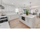 Bright and modern kitchen with quartz countertops, stainless steel appliances, and access to an open dining area at 3501 Providence Rd, Charlotte, NC 28211