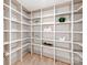 Large, walk-in pantry with custom shelving and wood floors at 3501 Providence Rd, Charlotte, NC 28211