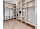 Large walk-in closet features light wood floors and custom built-in shelving and storage at 3501 Providence Rd, Charlotte, NC 28211