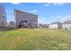Spacious backyard with a patio, outdoor furniture, slide, and lush green grass, ideal for recreation and relaxation at 356 Runner Stone Ln, Fort Mill, SC 29715
