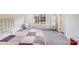 Cozy bedroom featuring a checkered bedspread, comfortable chair, and natural light at 356 Runner Stone Ln, Fort Mill, SC 29715