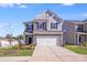Charming two-story home with stone accents, well-maintained lawn, and a two-car garage at 356 Runner Stone Ln, Fort Mill, SC 29715