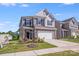 Charming two-story home with stone accents, well-maintained lawn, and a two-car garage at 356 Runner Stone Ln, Fort Mill, SC 29715