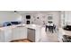 Open-concept kitchen with white cabinets, stainless steel appliances, and adjacent dining area with outdoor access at 356 Runner Stone Ln, Fort Mill, SC 29715