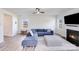 Comfortable living room featuring a fireplace, ceiling fan, large sectional sofa, and wood flooring at 356 Runner Stone Ln, Fort Mill, SC 29715