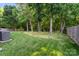 Large backyard with mature trees and a green lawn at 3604 Braefield Dr, Indian Trail, NC 28079