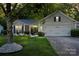 Inviting home featuring a manicured lawn, mature tree, and a two-car garage at 3604 Braefield Dr, Indian Trail, NC 28079