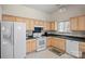 Kitchen featuring a white refrigerator, light colored cabinets, and dark countertops at 3604 Braefield Dr, Indian Trail, NC 28079