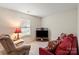Cozy living room featuring a plush armchair, sofa and television at 3604 Braefield Dr, Indian Trail, NC 28079