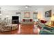Comfortable living room featuring a plaid sofa, floral armchair and natural light from the window at 3604 Braefield Dr, Indian Trail, NC 28079