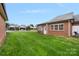 Brick home featuring a cozy patio and well-maintained lawn in a desirable neighborhood at 3951 Jasmine Ln, Denver, NC 28037