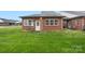 Brick home featuring a cozy patio and well-maintained lawn, perfect for outdoor relaxation at 3951 Jasmine Ln, Denver, NC 28037