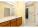 Well-lit bathroom with a sink vanity, large mirror, a bathtub, and a walk in closet at 3951 Jasmine Ln, Denver, NC 28037