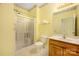 Bathroom with glass enclosed shower, single sink vanity, and decorative wallpaper trim at 3951 Jasmine Ln, Denver, NC 28037
